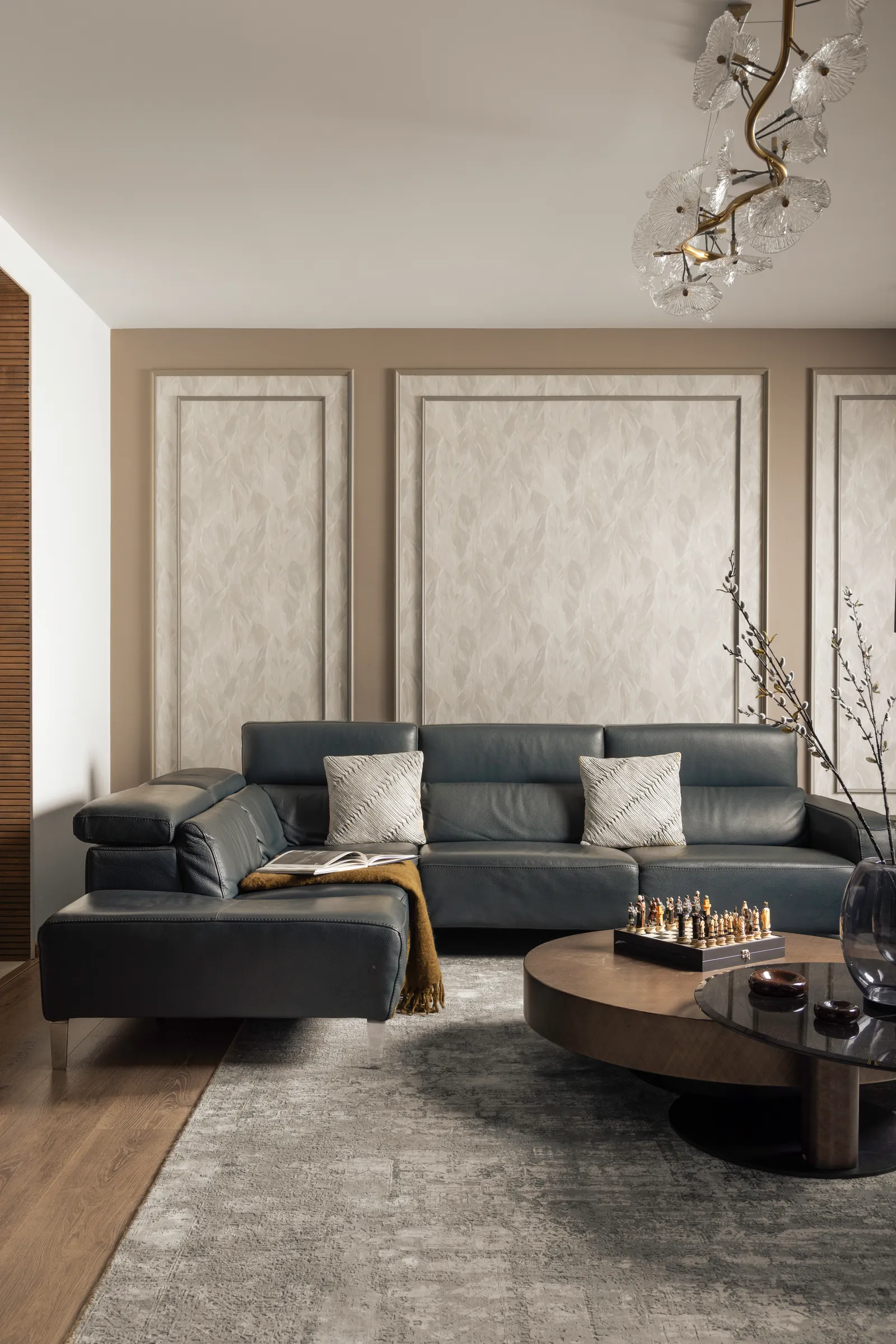 Living room with dark leather sectional and panelled walls — Seema Katta Svasa